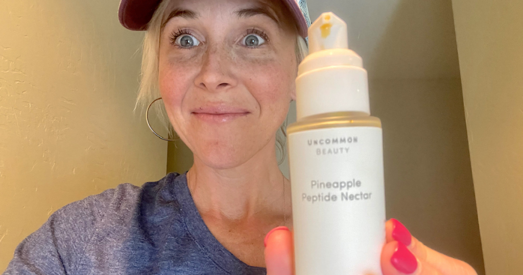 woman holding Uncommon James Beauty product, Pineapple Peptide Nectar Serum