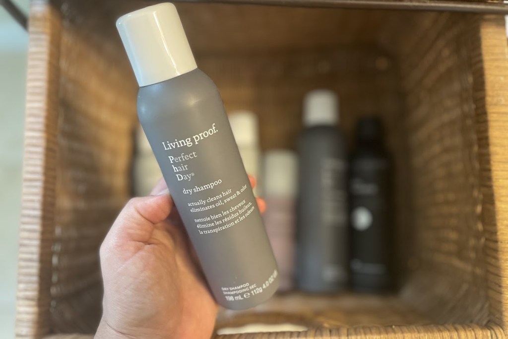 Hand holding Living Proof Perfect Hair Day Dry Shampoo