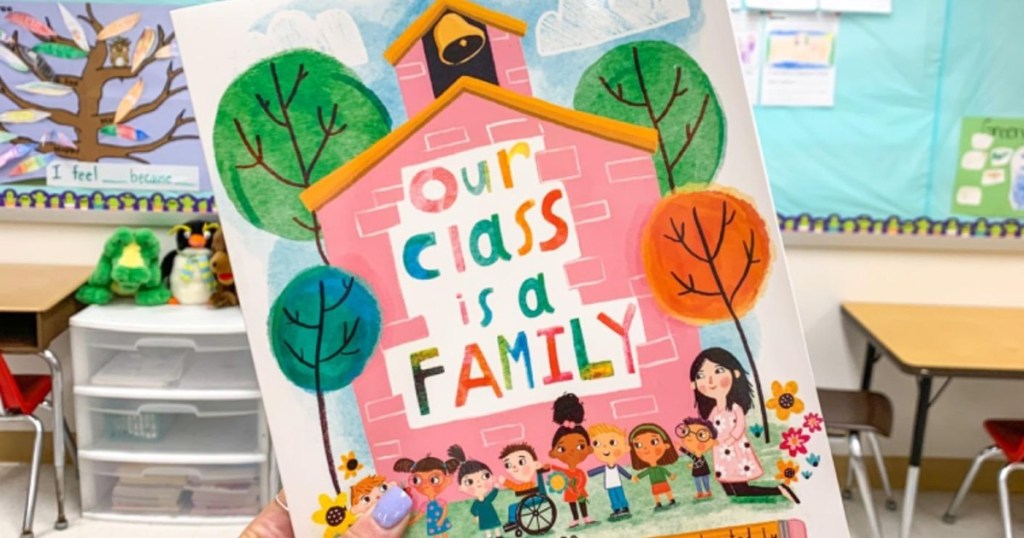 holding 'Our Class Is a Family' book
