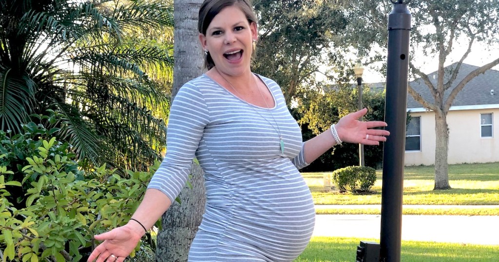 pregnant woman with hands out to her side