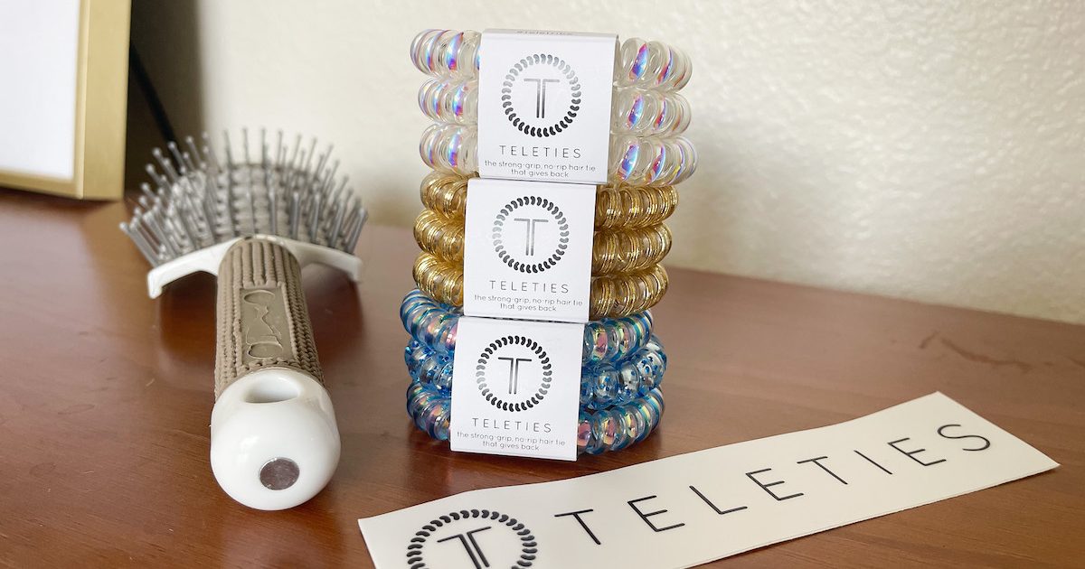 stack of colorful coiled hair ties on dresser with brush
