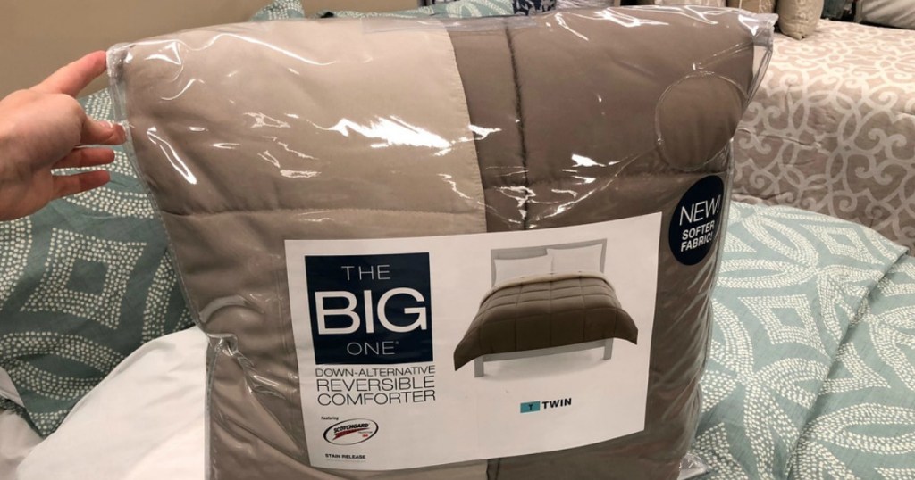 a hand holding The Big One reversible comforter in store