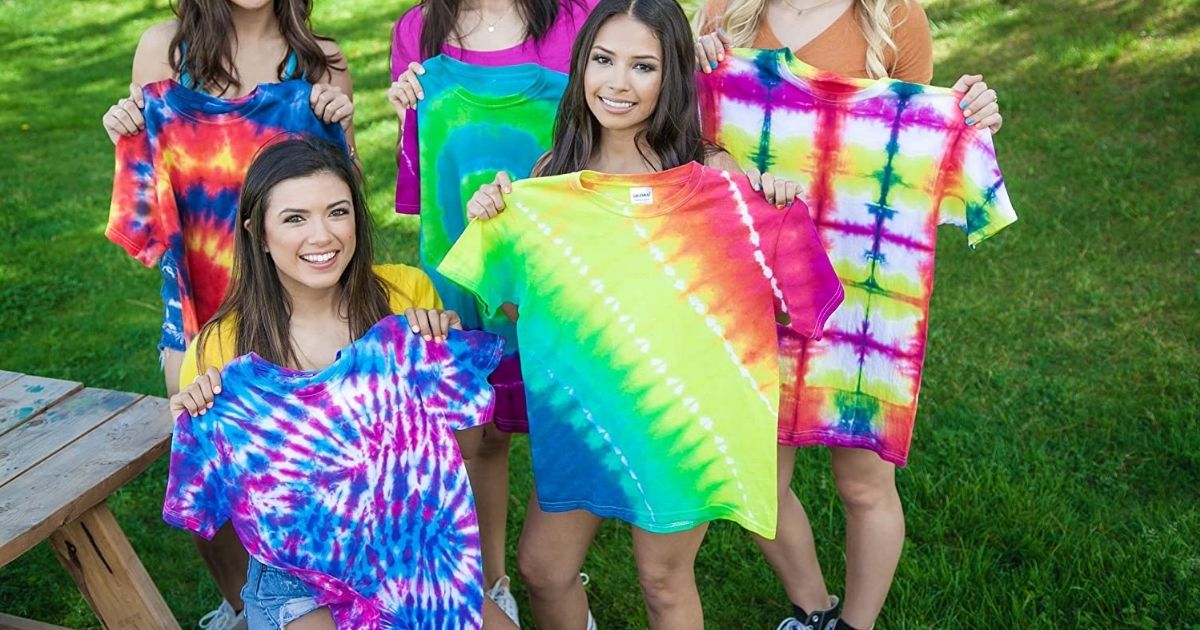 girls holding up tie dyed shirts