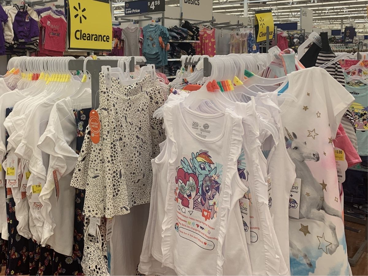 girls tees and skirts hanging on clearance rack in store