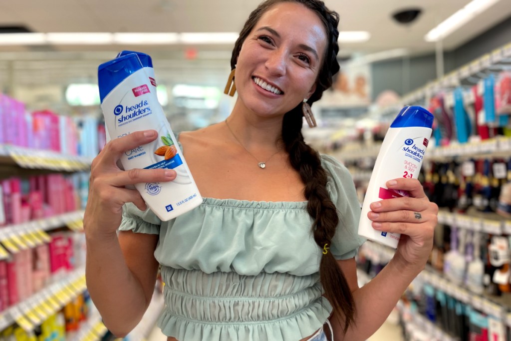 woman holding head & shoulders items