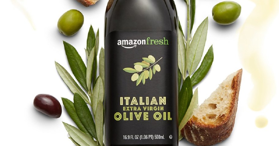 bottle of extra virgin olive oil, olive leaves, olives and bread