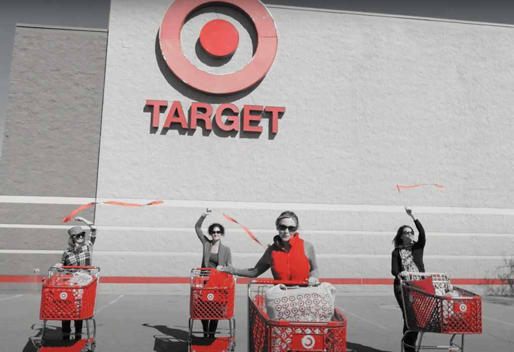 four woman with target carts standing in front of target storefront