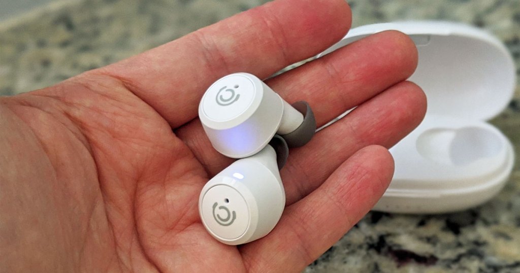 hand holding pair of white earbuds