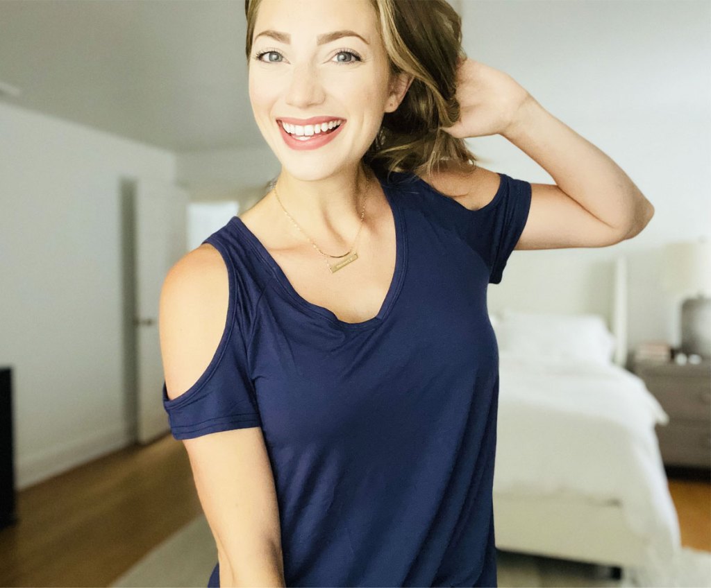 woman wearing blue cold shoulder tunic top