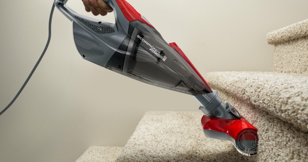gray and red vaccum on stairs 