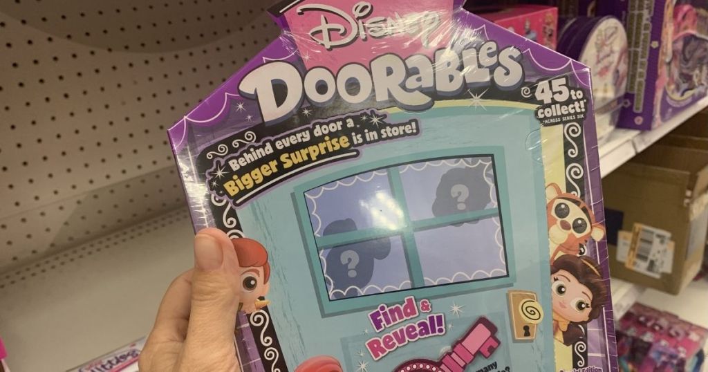 hand holding a Disney Doorables box