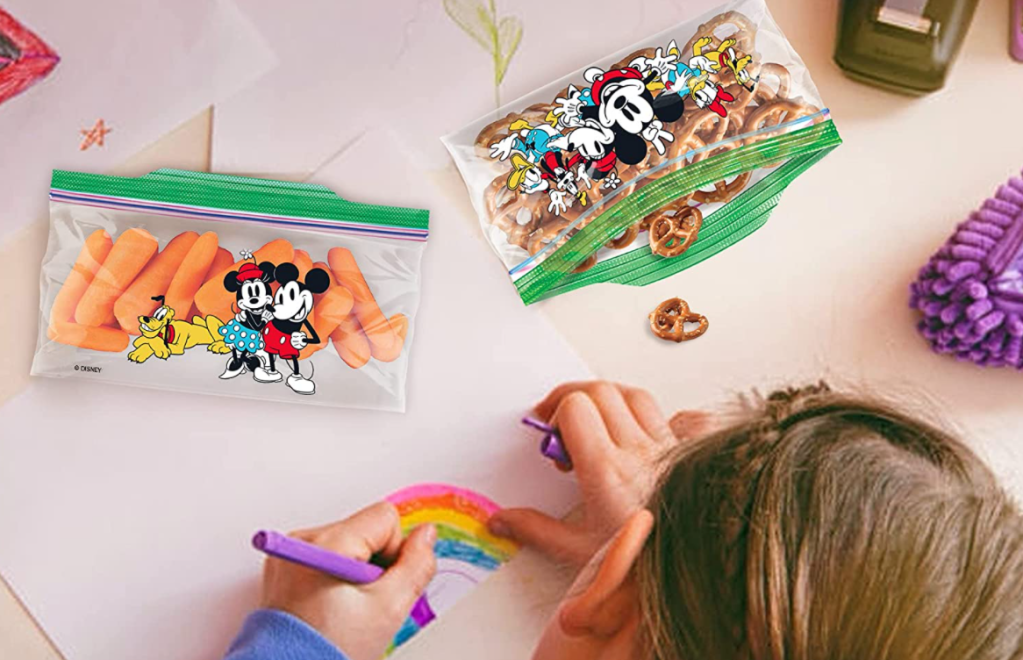 girl coloring with two Ziploc snack bags next to her