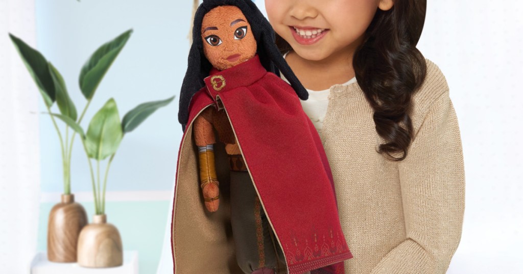 girl holding Disney Raya plush