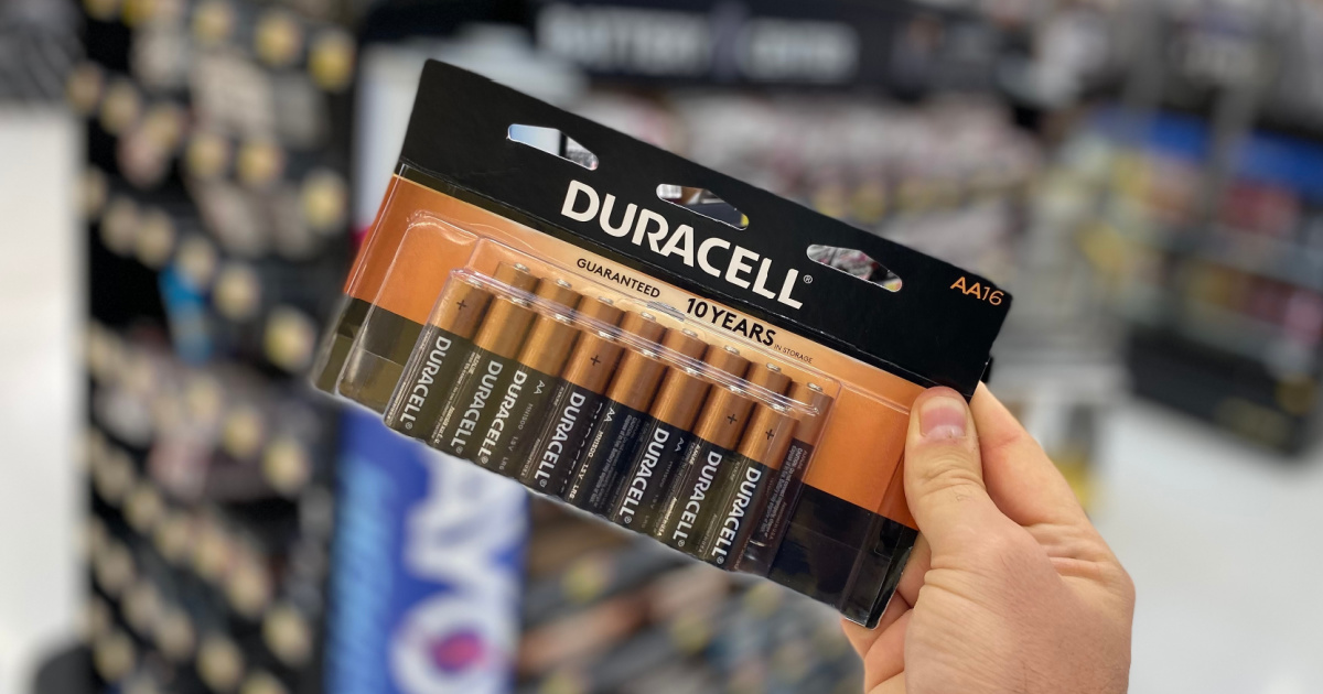hand holding pack of AA batteries in store