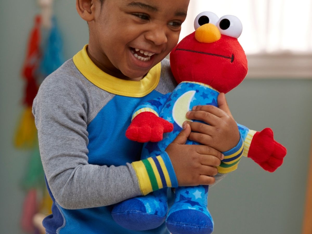 little boy holding Elmo plush