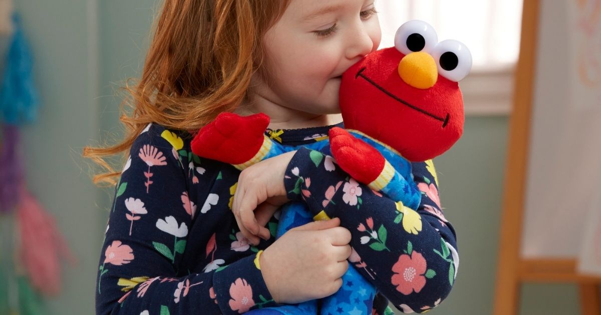 Little girl kissing Elmo Plush