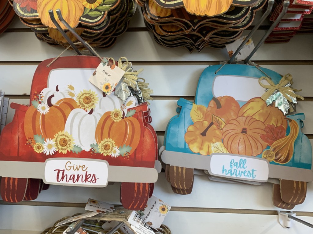 two fall trucks with pumpkins in trunk decor