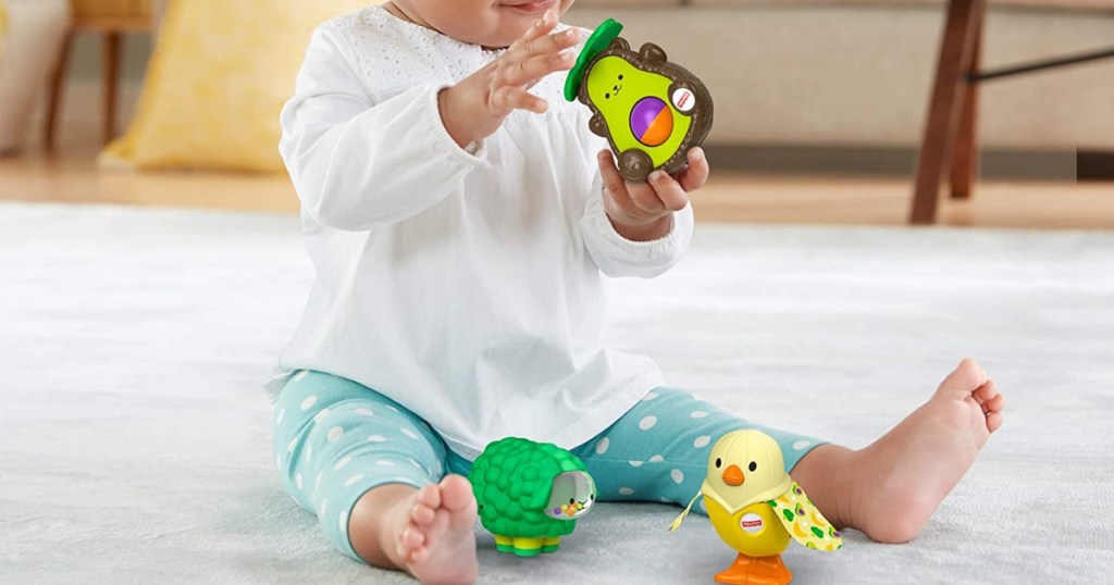 baby holding little avocado toy.jpg