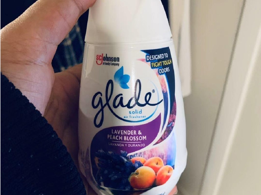 hand holding solid glade air freshener