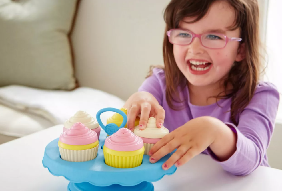 girl playing with toy cupcakes