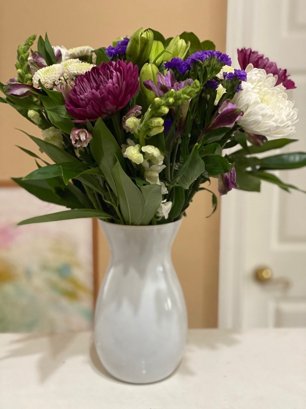 bouquet of flowers sitting in vase on counter