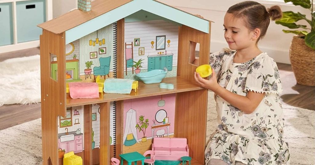 girl playing with a dollhouse