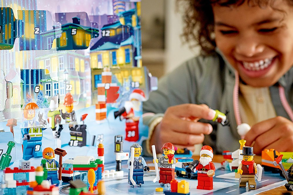 girl playing with a LEGO Advent calendar