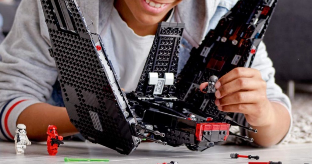 boy playing with LEGO kylo ren shuttle