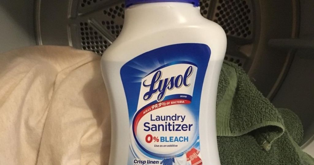 Lysol Laundry Sanitizer bottle with towels next to it