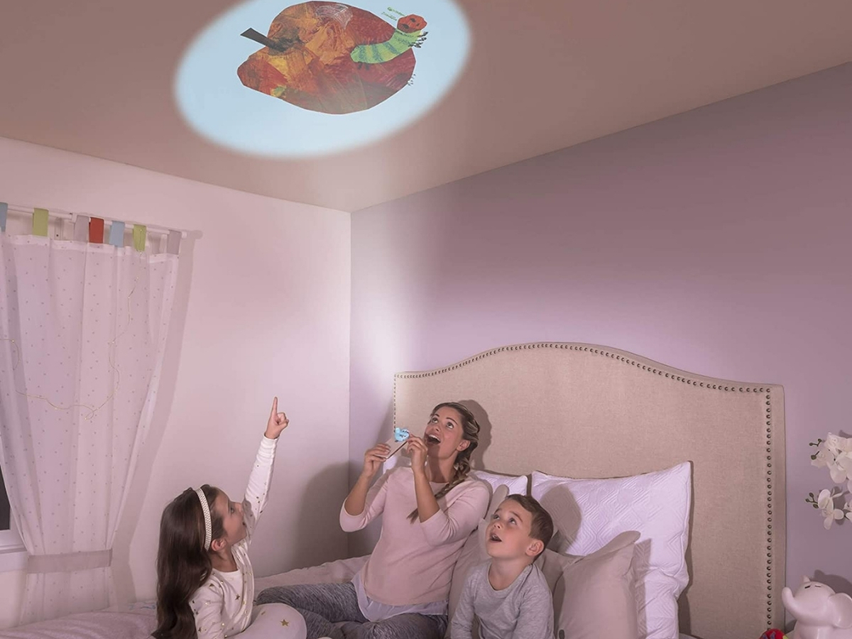 family with a moonlite story projector for smartphones