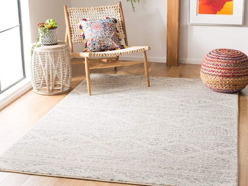 white and gray rug on floor with chair