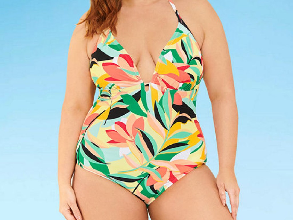 girl wearing colorful tropical one-piece swimsuit