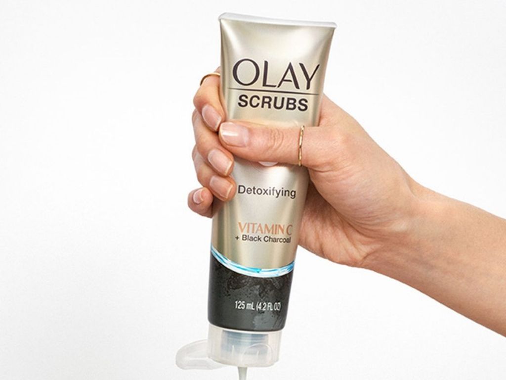 hand squeezing Olay Scrubs bottle