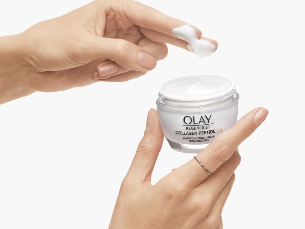finger taking Olay Regenerist cream from jar