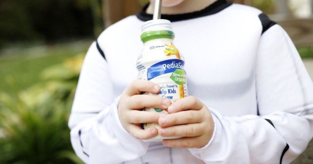 kid holding a nutritional shake