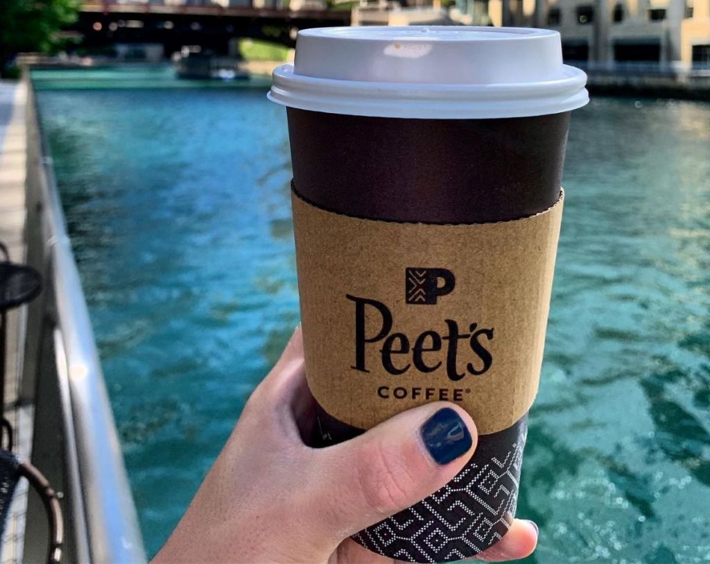 hand holding a Peet's coffee cup