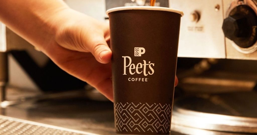 hand holding a cup of Peet's coffee