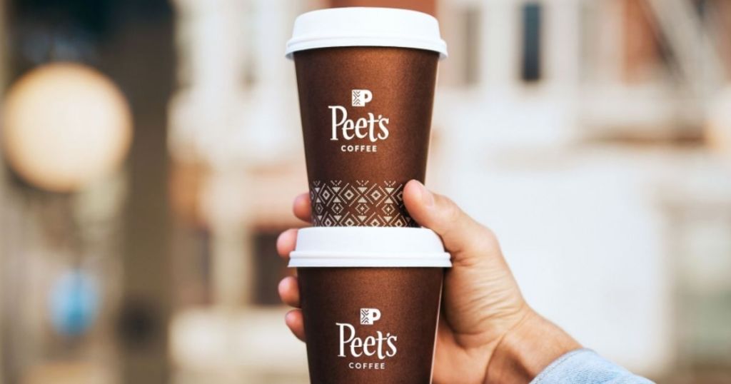 hand holding two cups of Peet's coffee