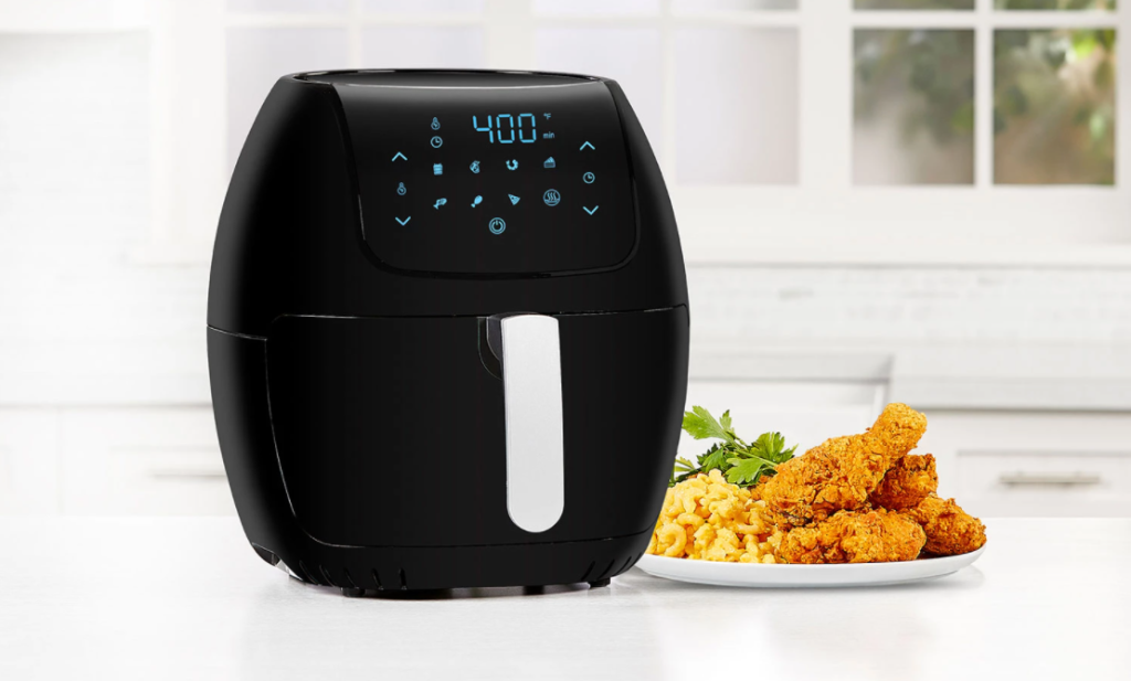 air fryer next to a plate of food
