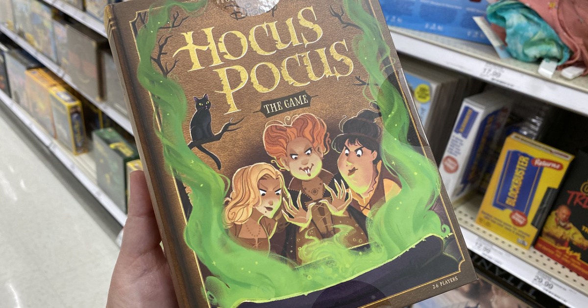 hand holding the hocus pocus game box in front of a store shelf
