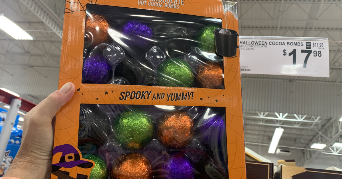 hand holding up a package of halloween-packaged hot cocoa bombs