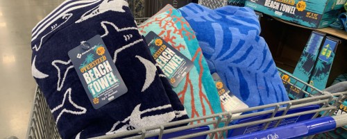 three large beach towels in store cart