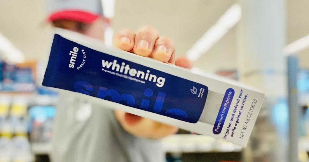person holding a box of Smile Direct Club Whitening Toothpaste