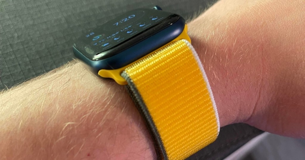 yellow apple watch band around wrist