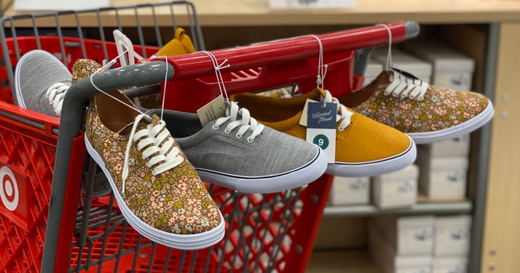 women's sneakers hanging from shopping cart