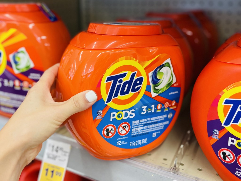 hand grabbing Tide pod packs