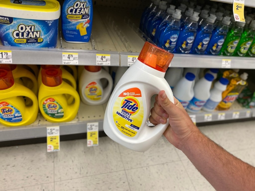 hand holding tide simply laundry detergent in store