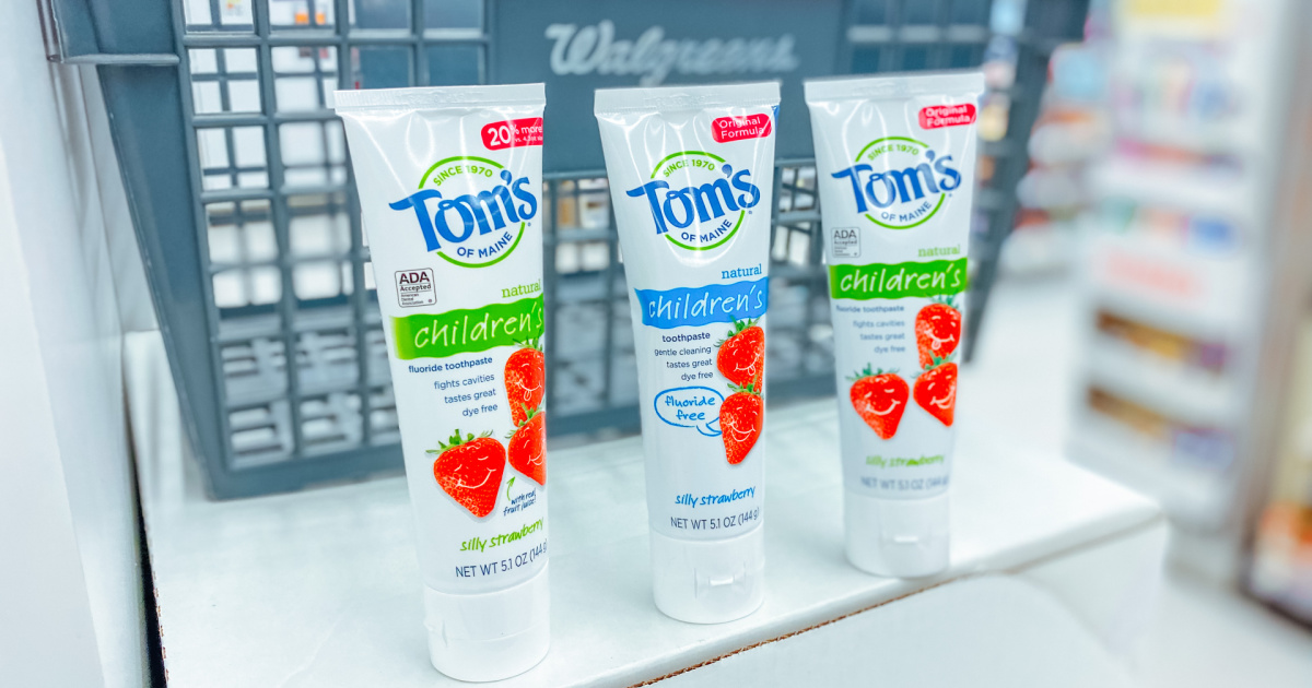 three tubes of toms toothpaste lined up in front of a walgreens basket in store