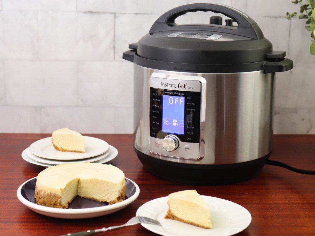 instant pot on table with cheesecake