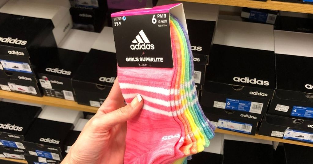 hand holding a pack of adidas socks